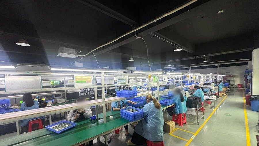 Wide view of a GPS tracker assembly line at a Shenzhen partner facility